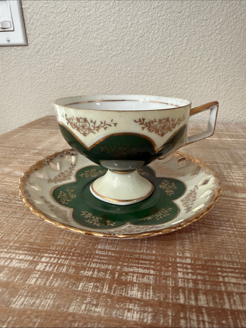 Vintage Japanese green and gold reticulated teacup, and pierced saucer.